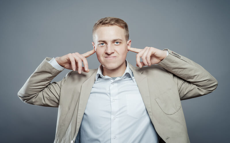 business man covering his ears