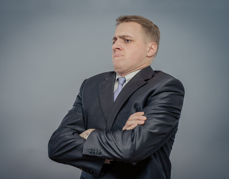 Annoyed male crosses his arms in disappointment