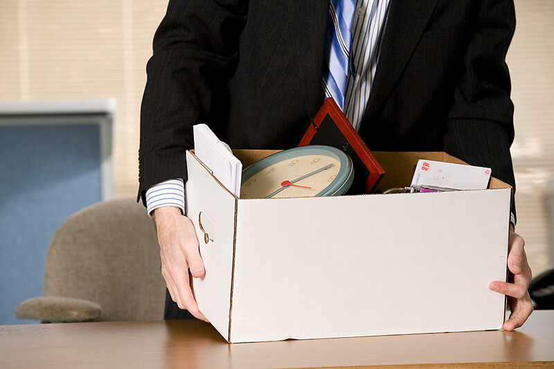 former employee taking their boxed items from workplace