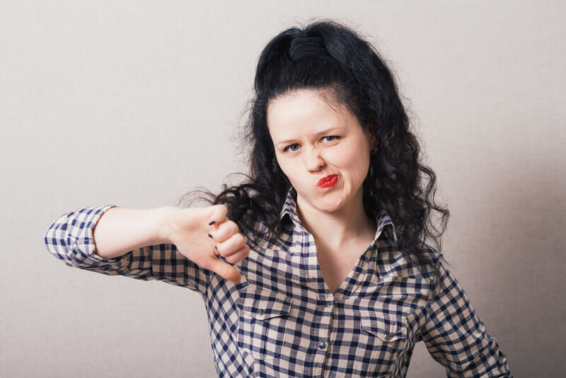 woman holding her thumb down