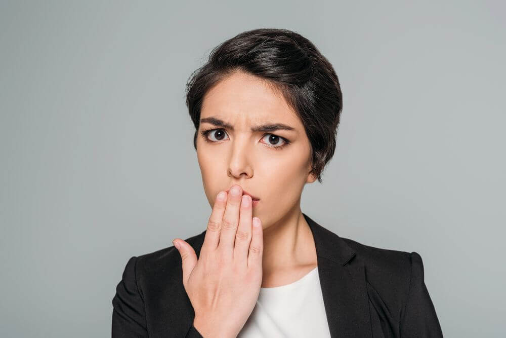 businesswoman covering mouth with hand