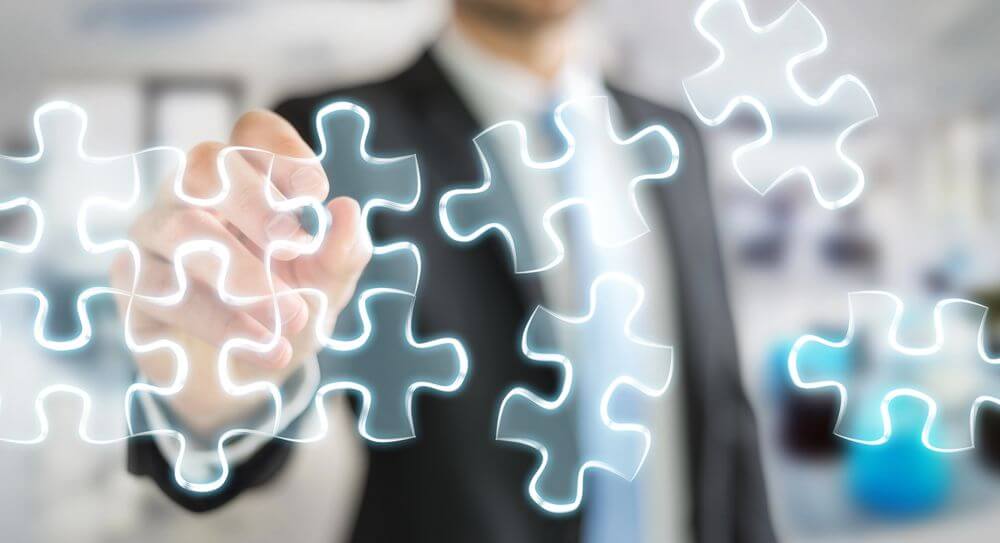 Businessman drawing hand-drawn puzzle pieces